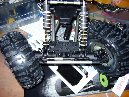 This image of the suspension on a remote controlled truck illustrates the clearance issues with wider tires. When you turn the wheels all the way right or left, they may touch the frame or suspension components if the tires are too wide. Tire clearance at full wheel turn